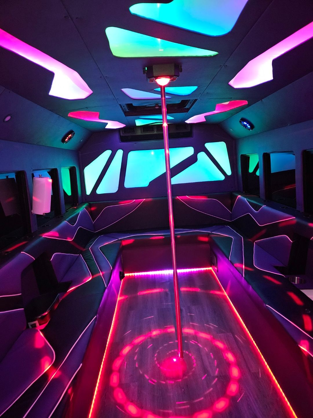 inside view of a white 20 passenger party bus for SATX with lights on