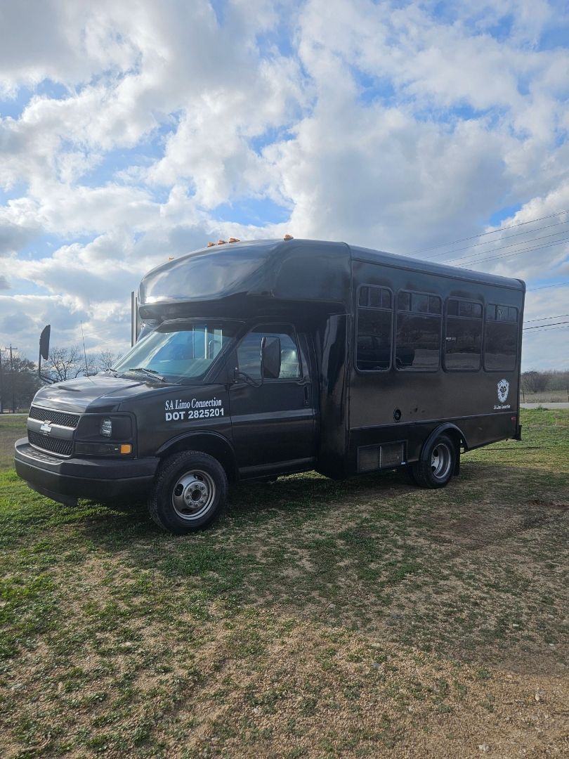 white 20 passenger party bus for SATX outside view