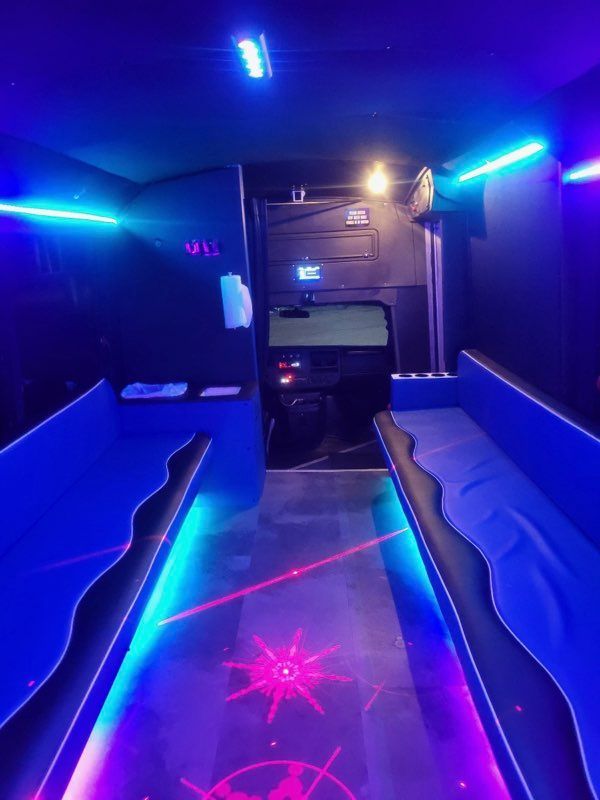 Blue Line San Antonio Party Bus Up to 16 passengers nighttime inside lights on view parked in Leon Springs