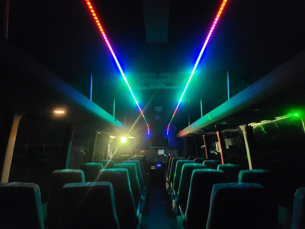 San Antonio Executive shuttle bus for up to 37 passengers night with lights on inside view SATX