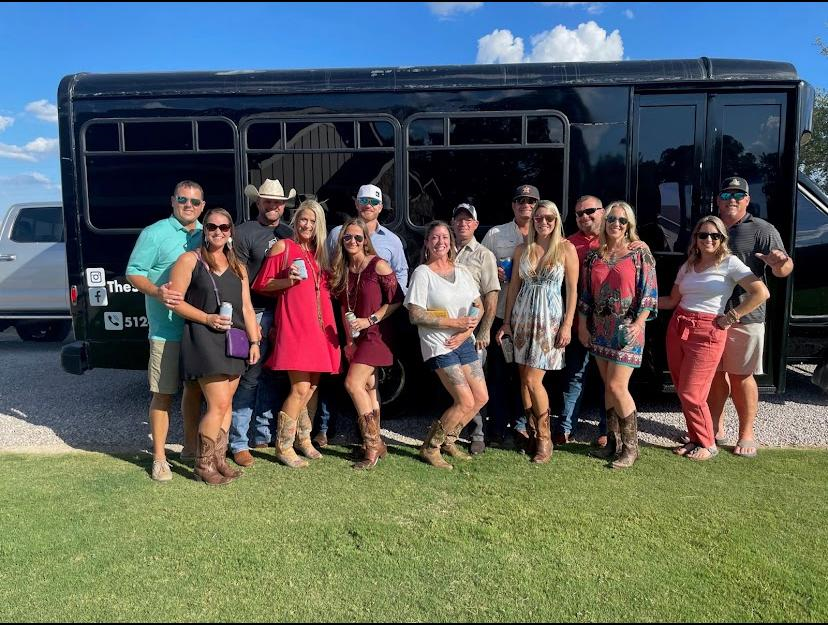 black Austin party bus with 14 passengers outside view