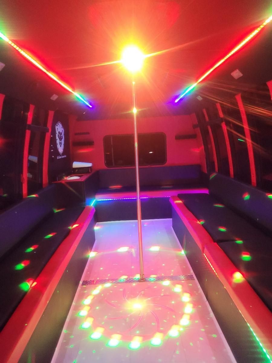 inside view of a white 20 passenger party bus for SATX with lights on