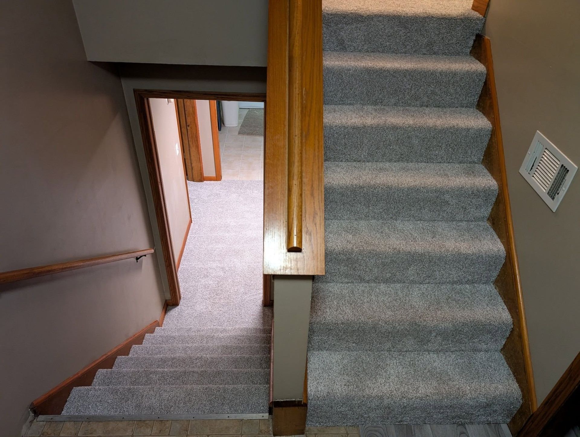 A set of stairs leading up to a basement in a house.