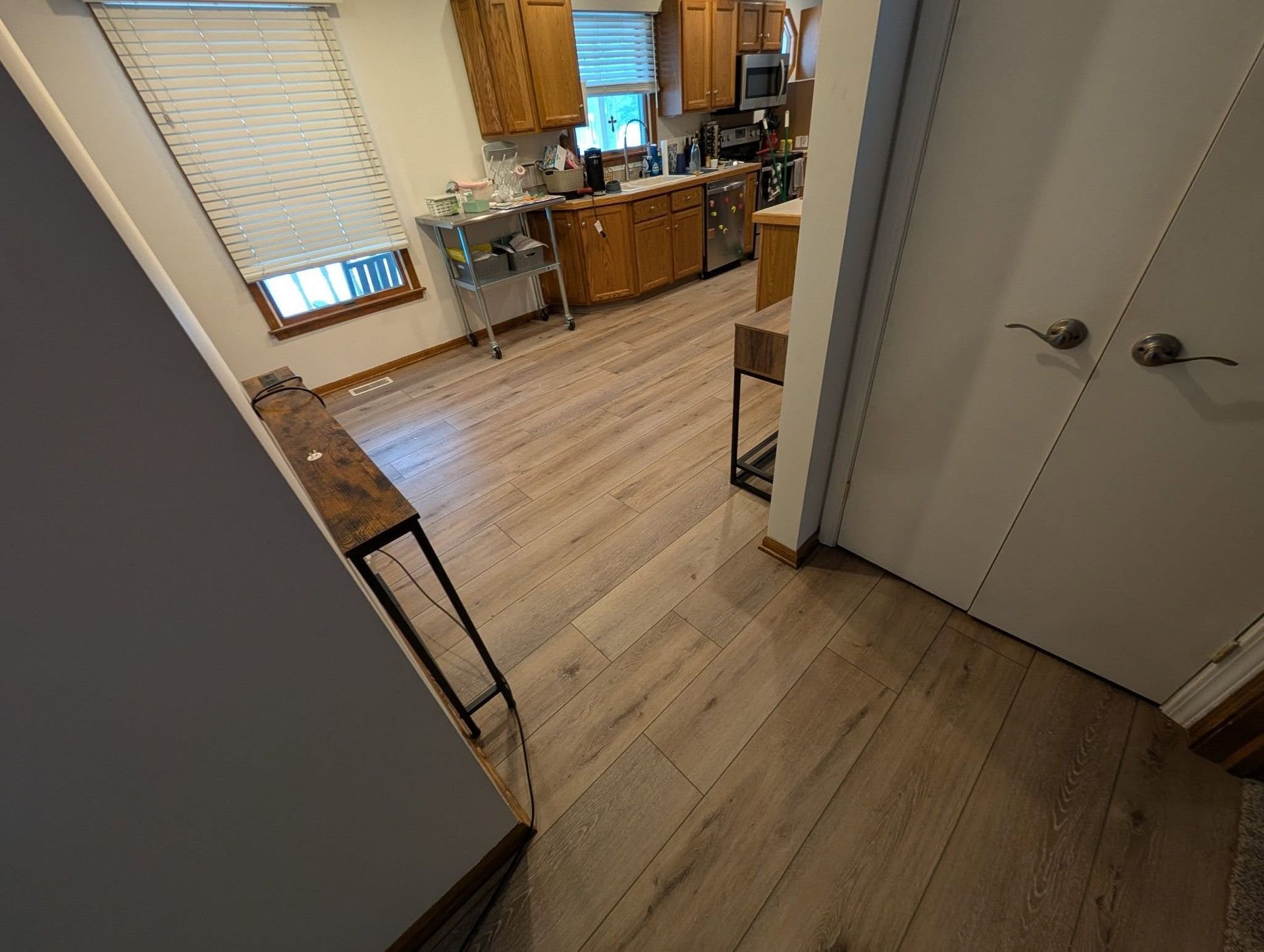 A kitchen with hardwood floors and stainless steel appliances.