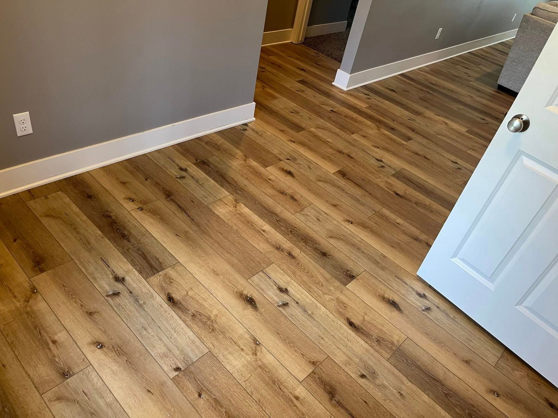 A room with hardwood floors and a white door.