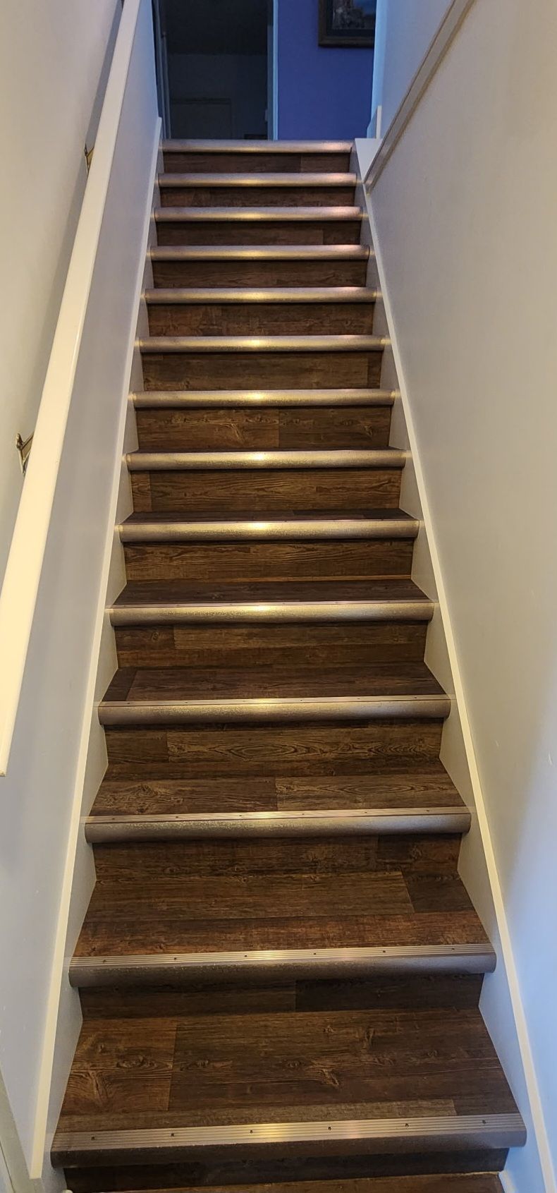 A set of wooden stairs leading up to the second floor of a house.