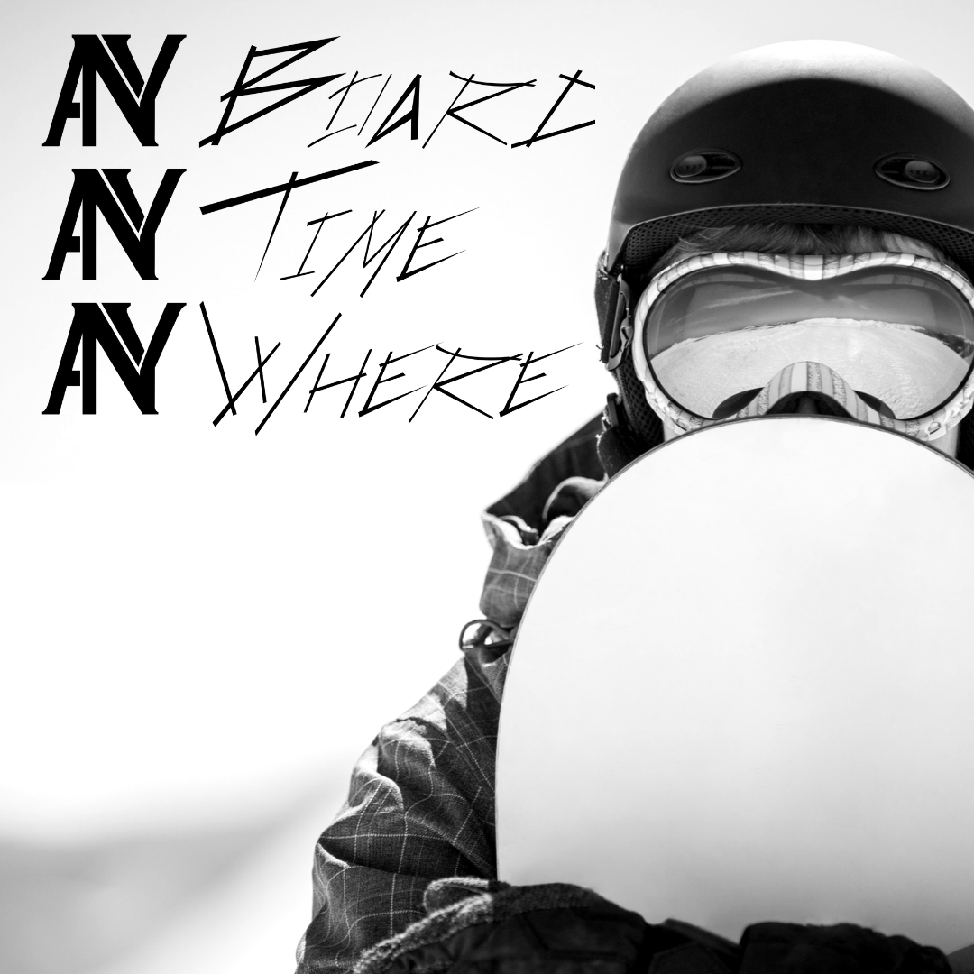 A person wearing a helmet and goggles is holding a snowboard with the words 