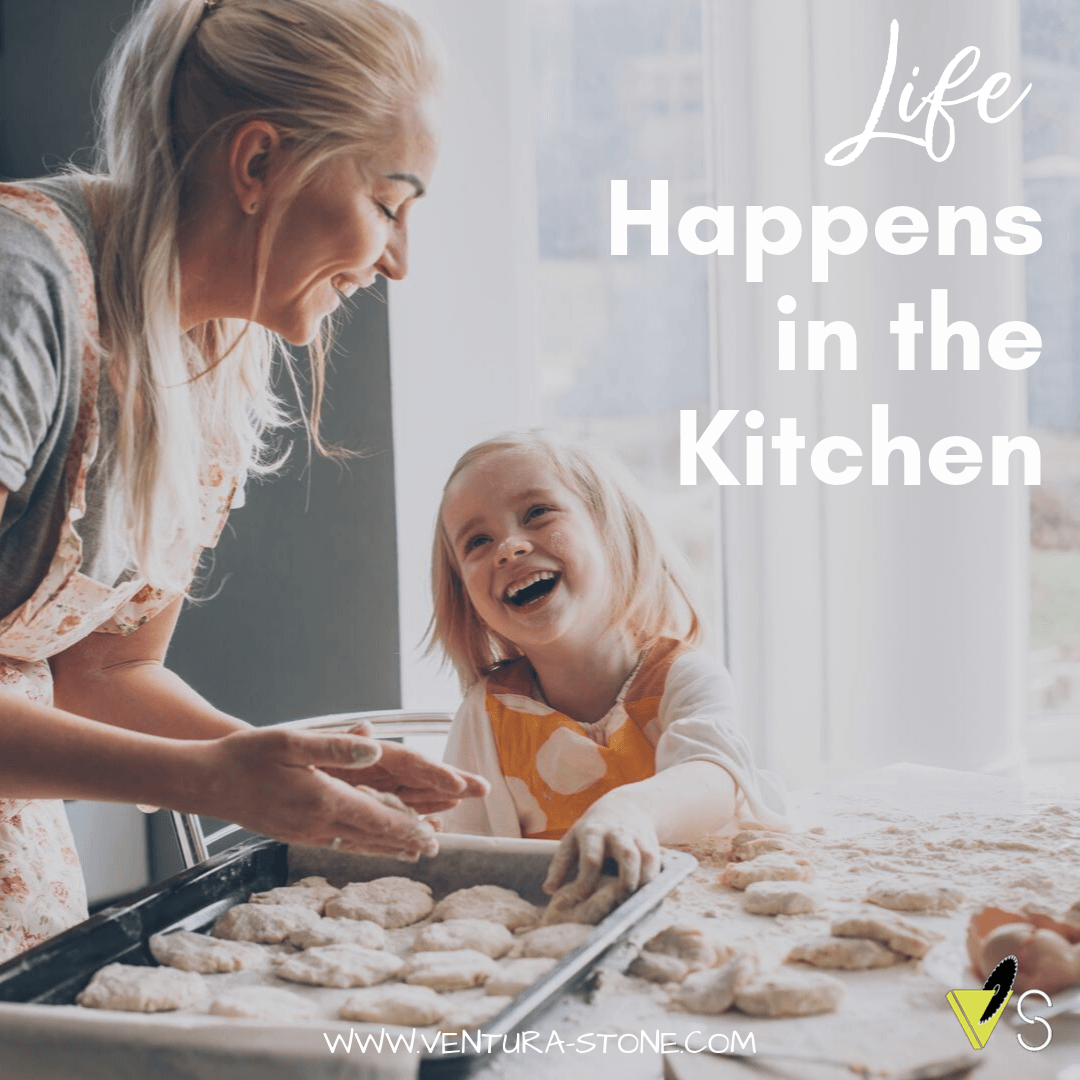 A woman and a little girl are baking cookies in the kitchen.