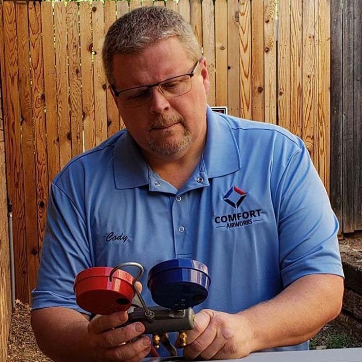 Cody is holding two valves in his hands. Cody is holding two valves in his hands.