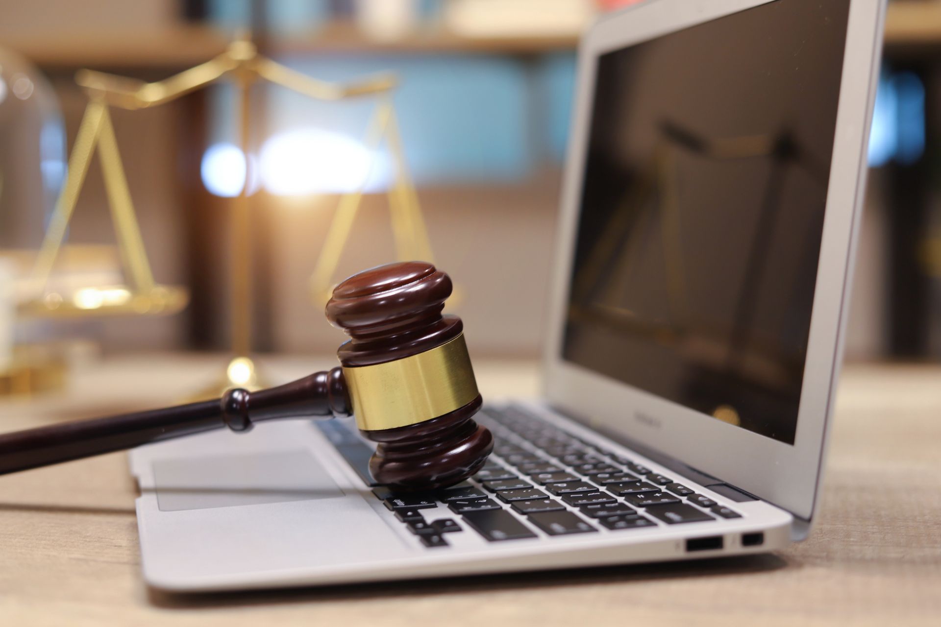 A judge's gavel rests on a laptop, symbolizing legal expertise at Houston & Alexander, PLLC