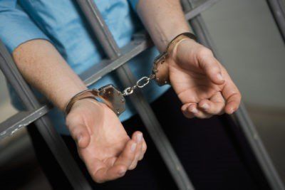 Man Behind Bars with Handcuffs — Chattanooga, TN — Houston & Alexander, PLLC