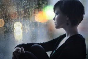 Sad Woman Looking at Window — Chattanooga, TN — Houston & Alexander, PLLC