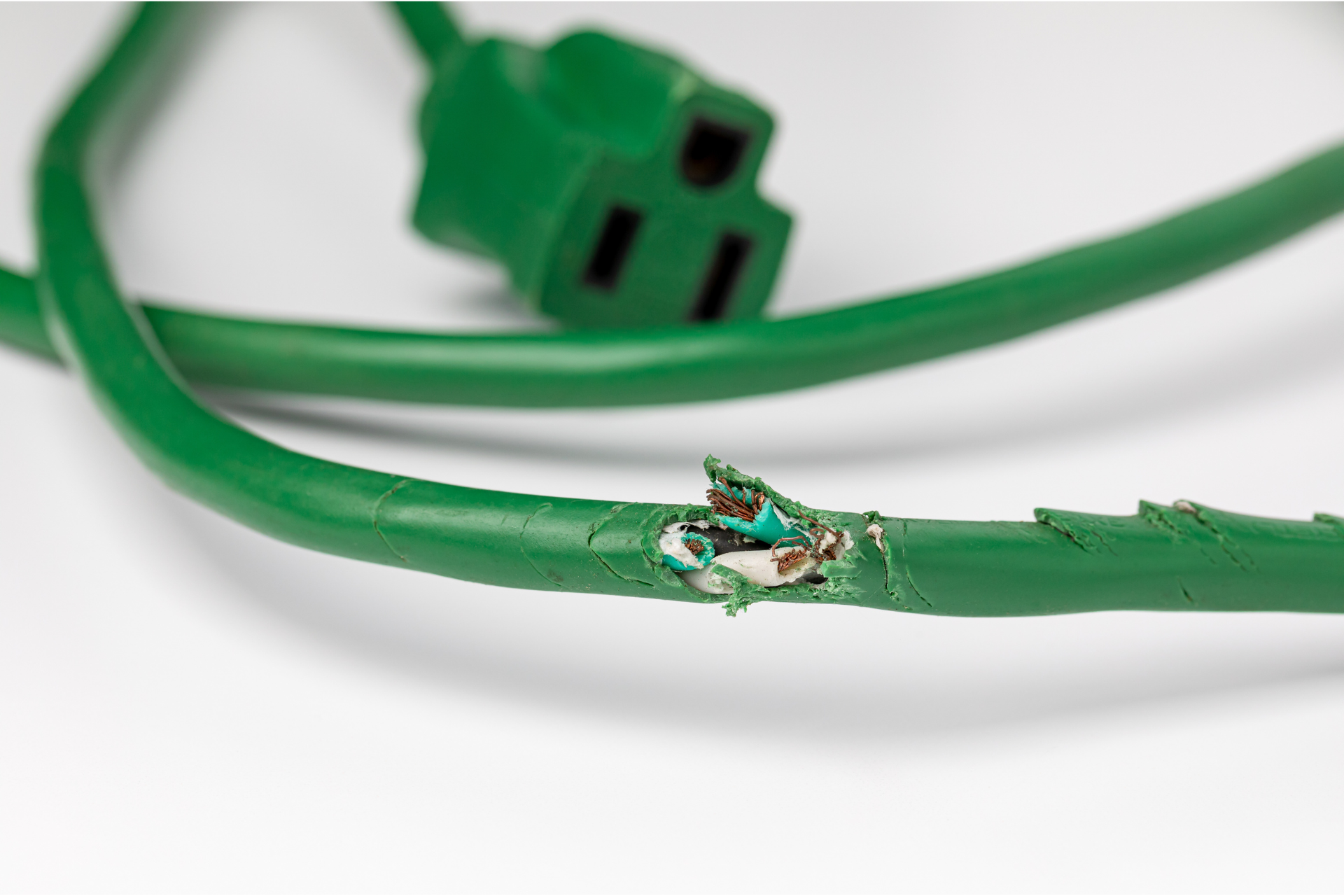 A green power cord with a hole in it