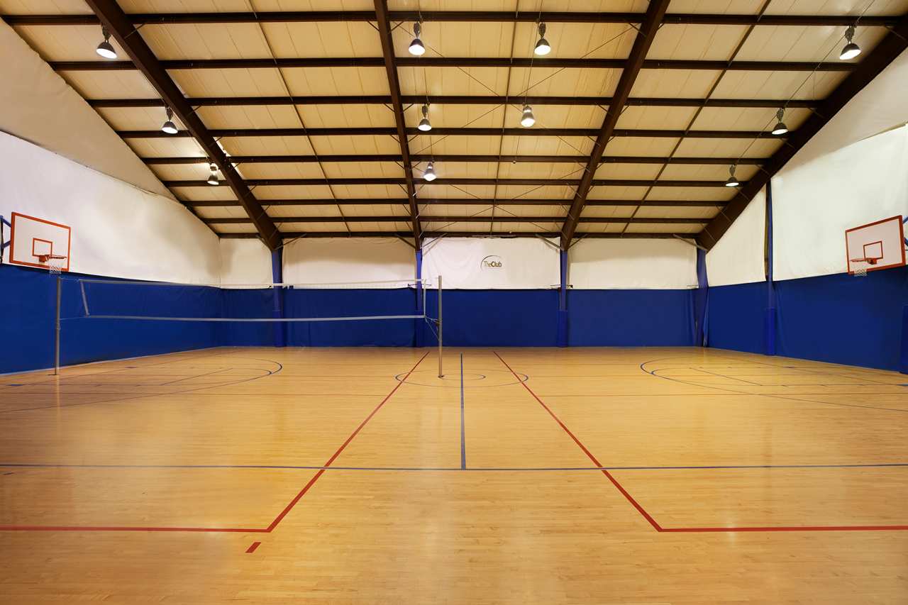 There is a volleyball court and a basketball court in the gym.