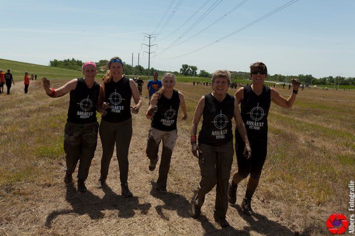 A group of women wearing black tank tops with a target on them