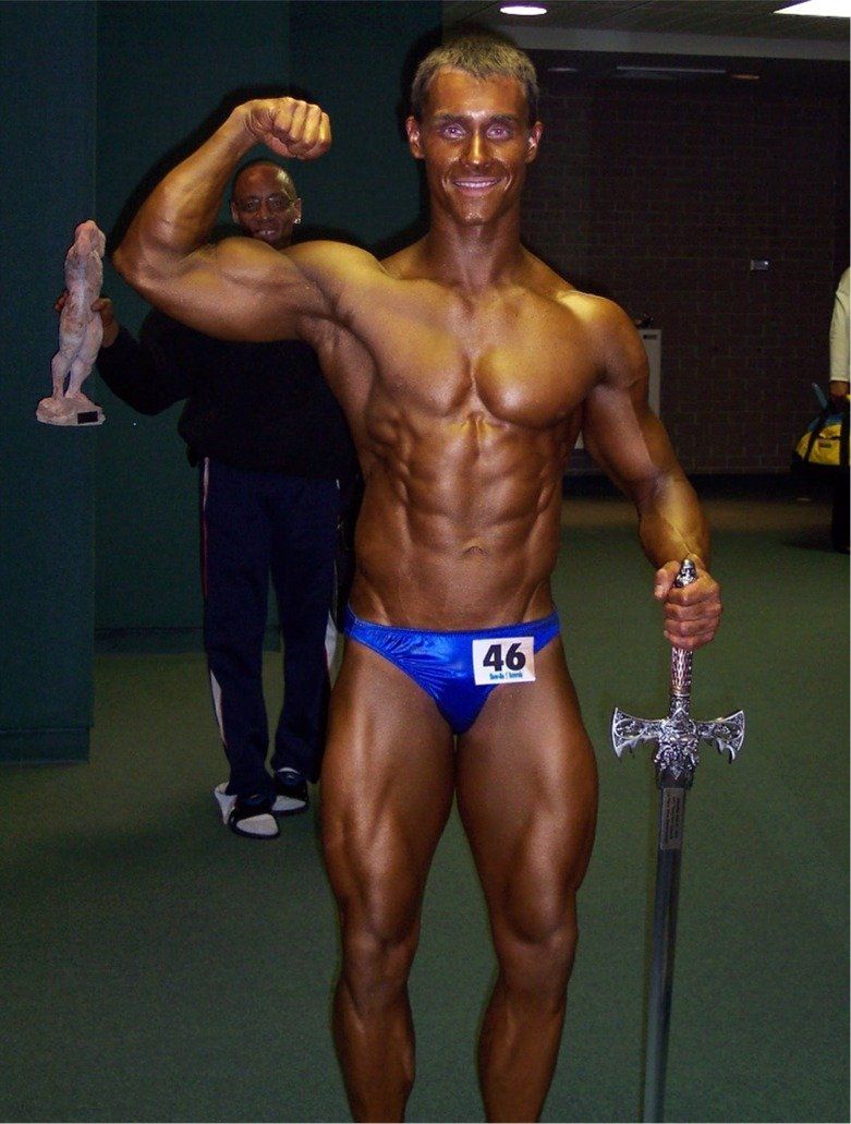 A bodybuilder with the number 46 on his underwear