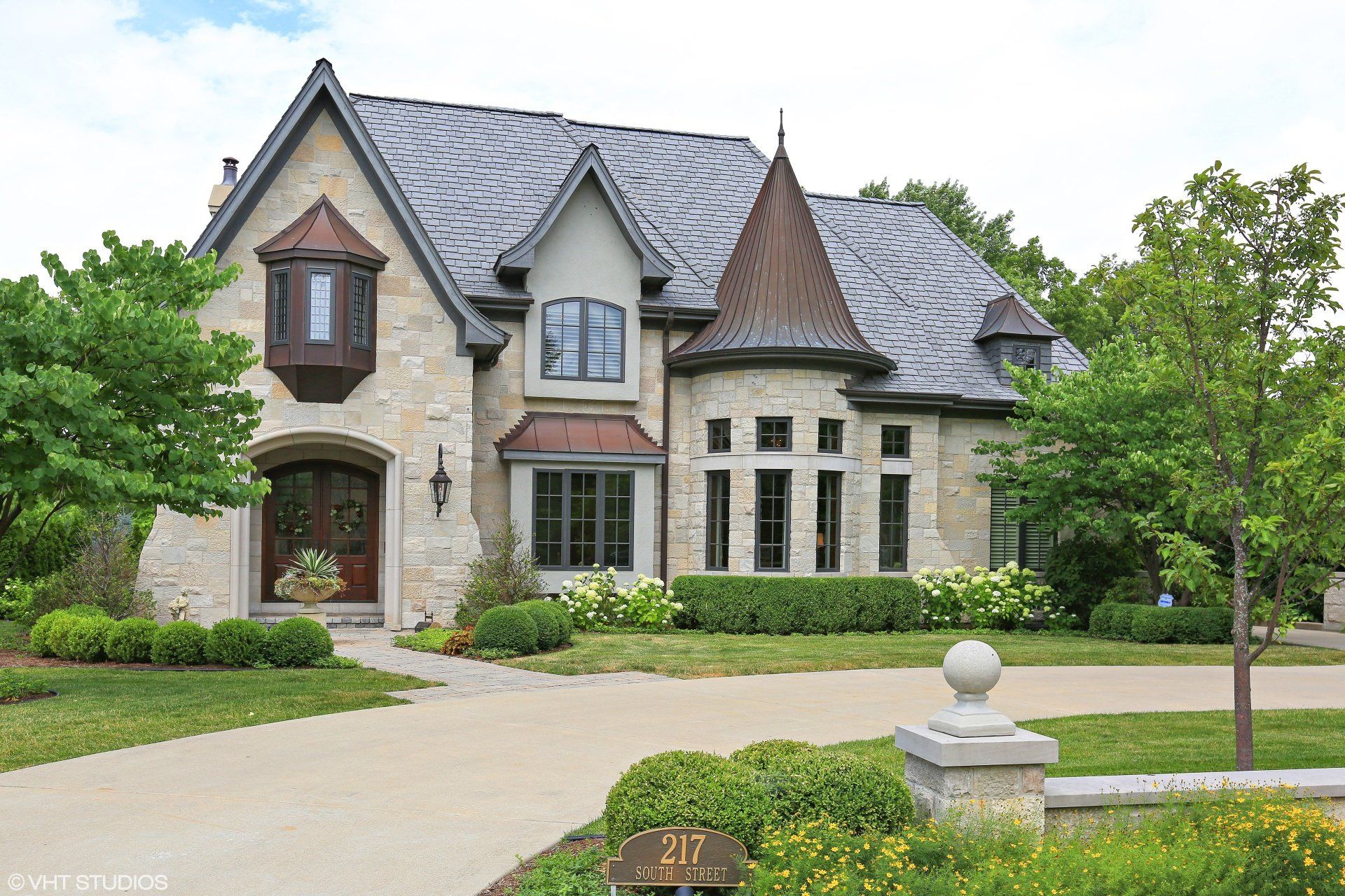 A large house with a gray roof is for sale