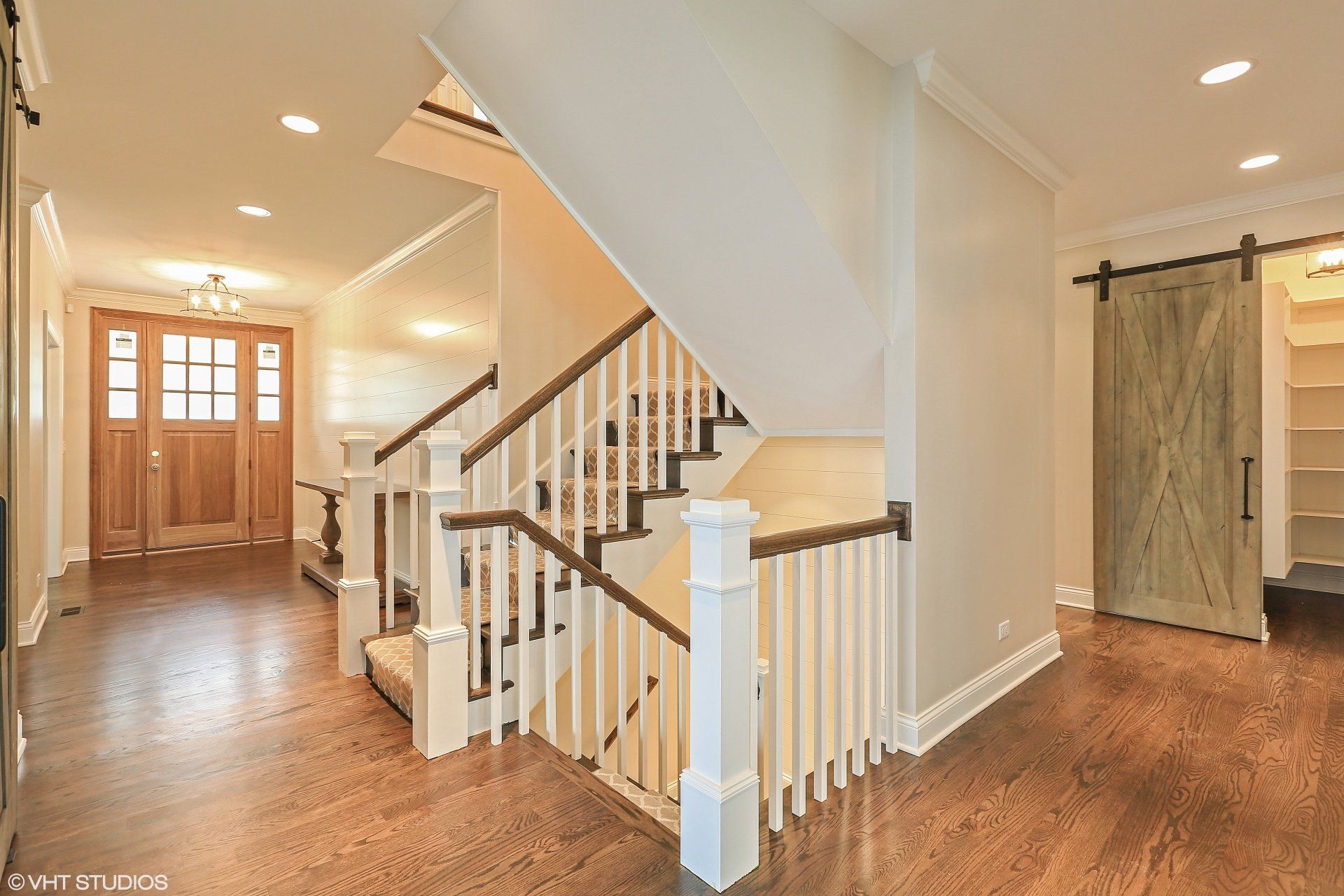 There is a staircase in the middle of the hallway.