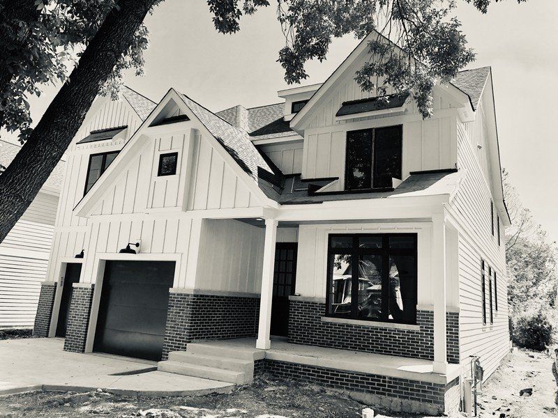 A black and white photo of a house under construction.