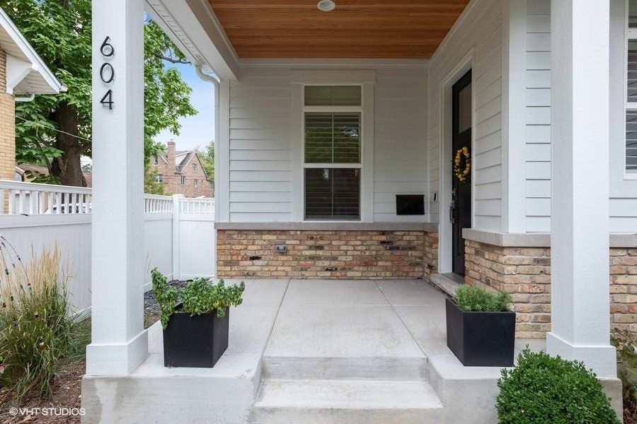 The front porch of a house with the number 604 on it.