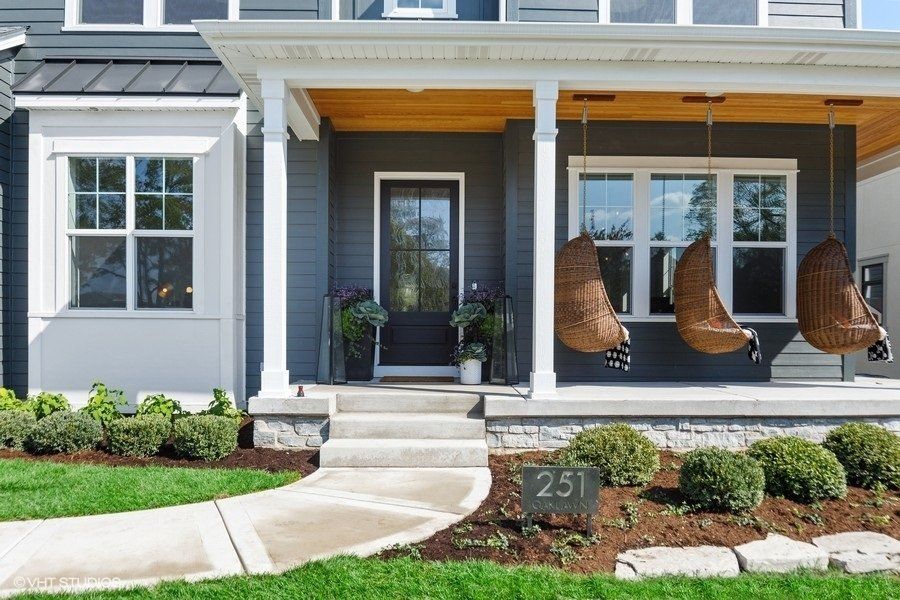 A house with a porch with swings and a sign that says 251