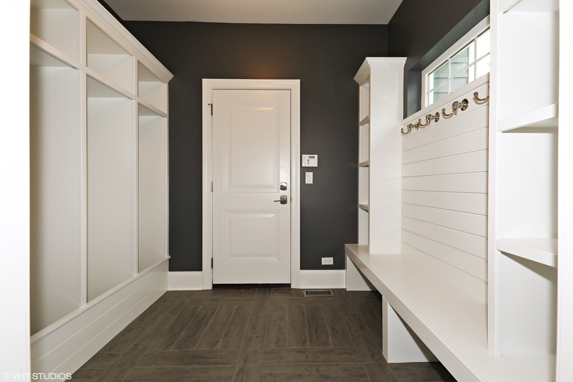 A hallway with a bench and a door that has the number 1 on it