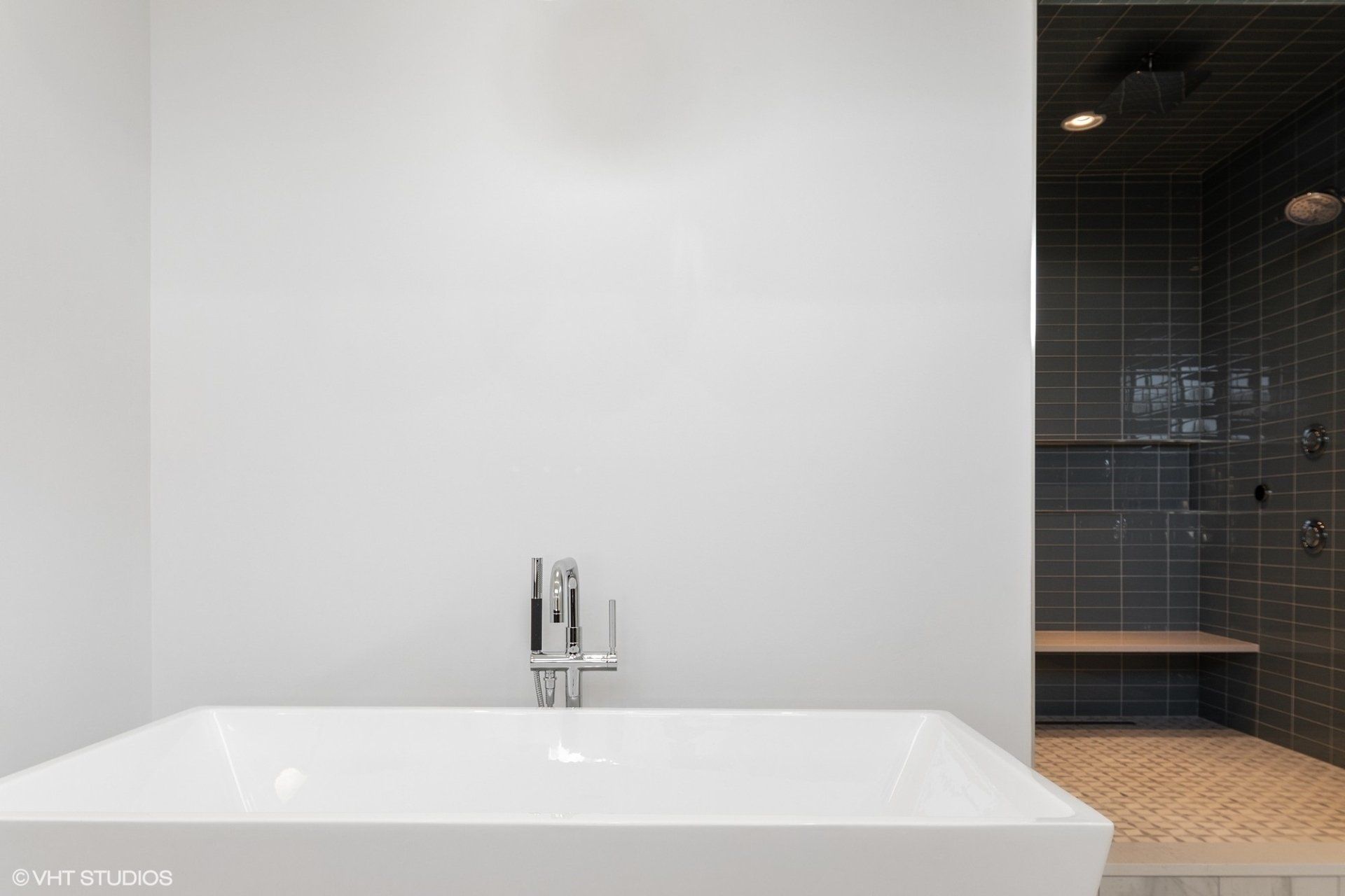 A bathroom with a bathtub and a shower.