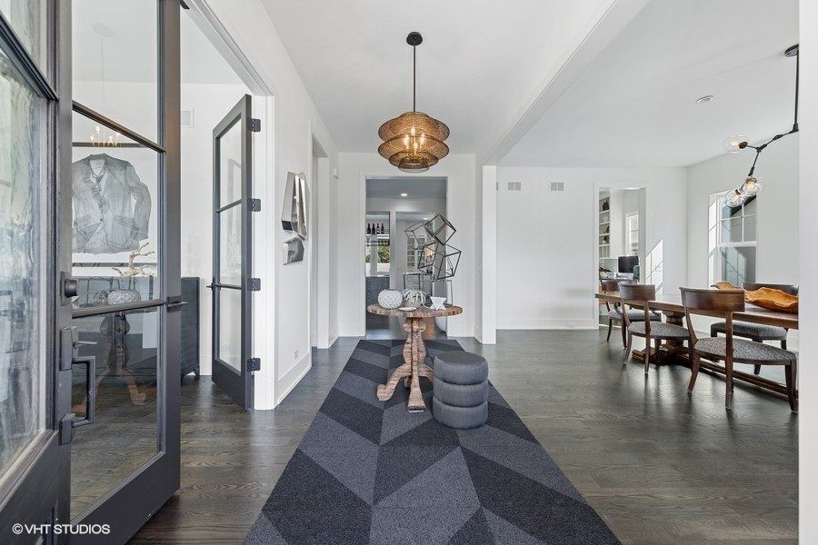 A hallway in a house with a black and white rug