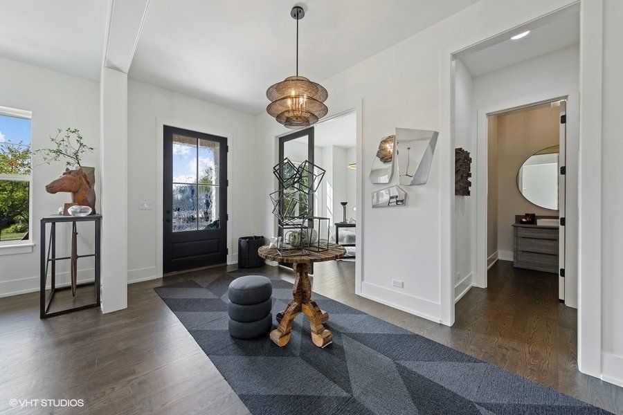 A living room with a table and a rug in it
