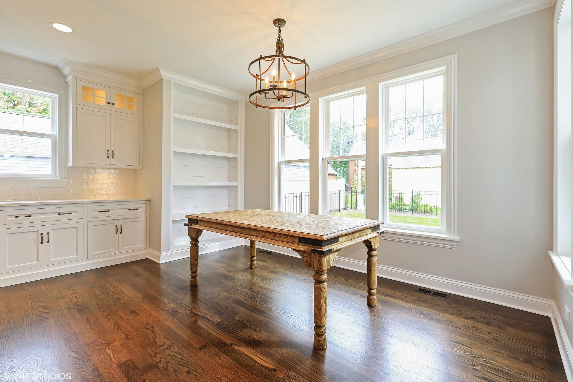 There is a wooden table in the middle of the room.