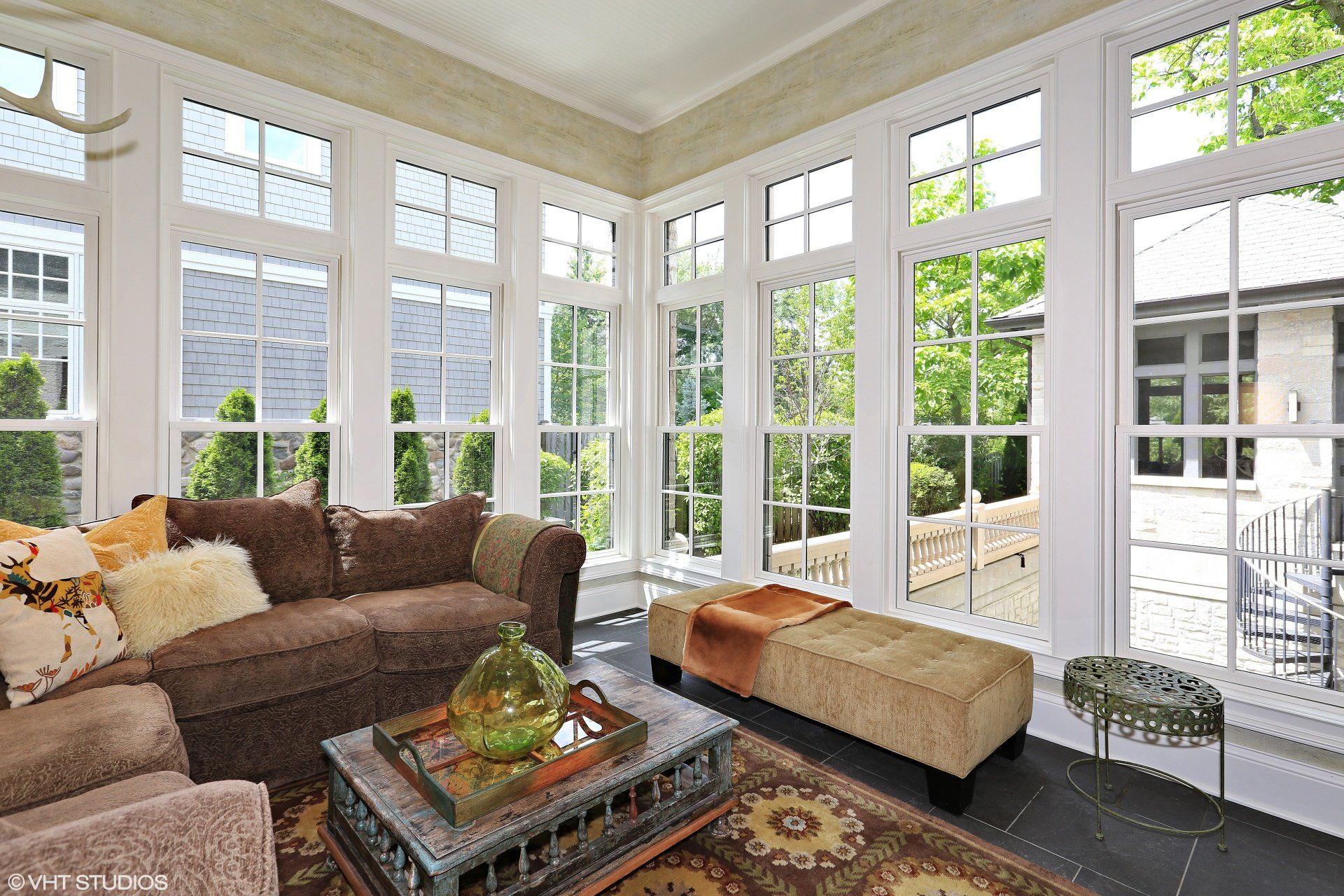 A living room filled with furniture and lots of windows.