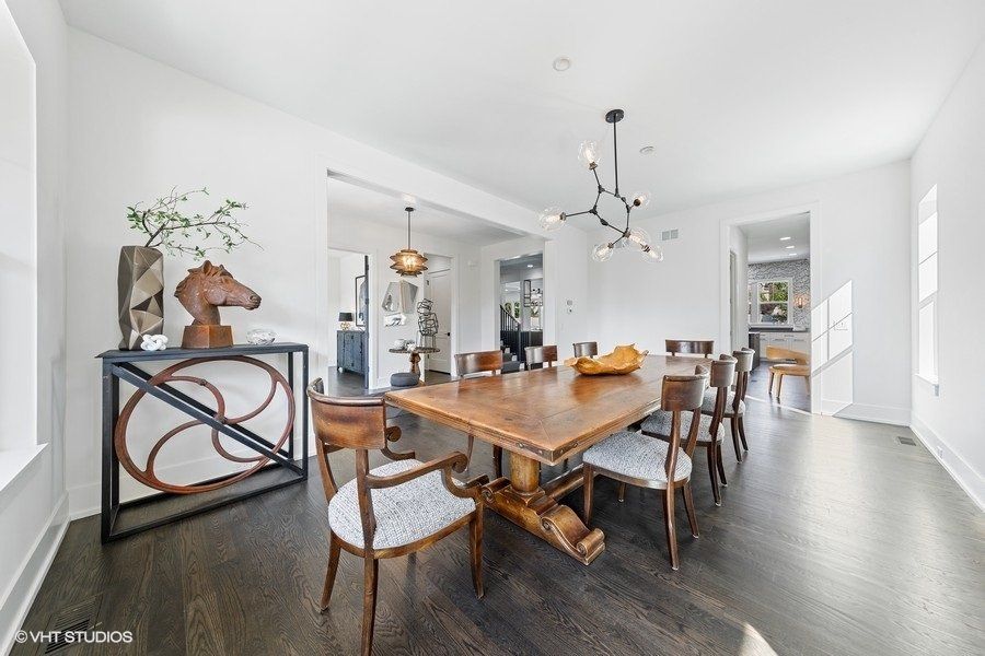A large dining room with a wooden table and chairs