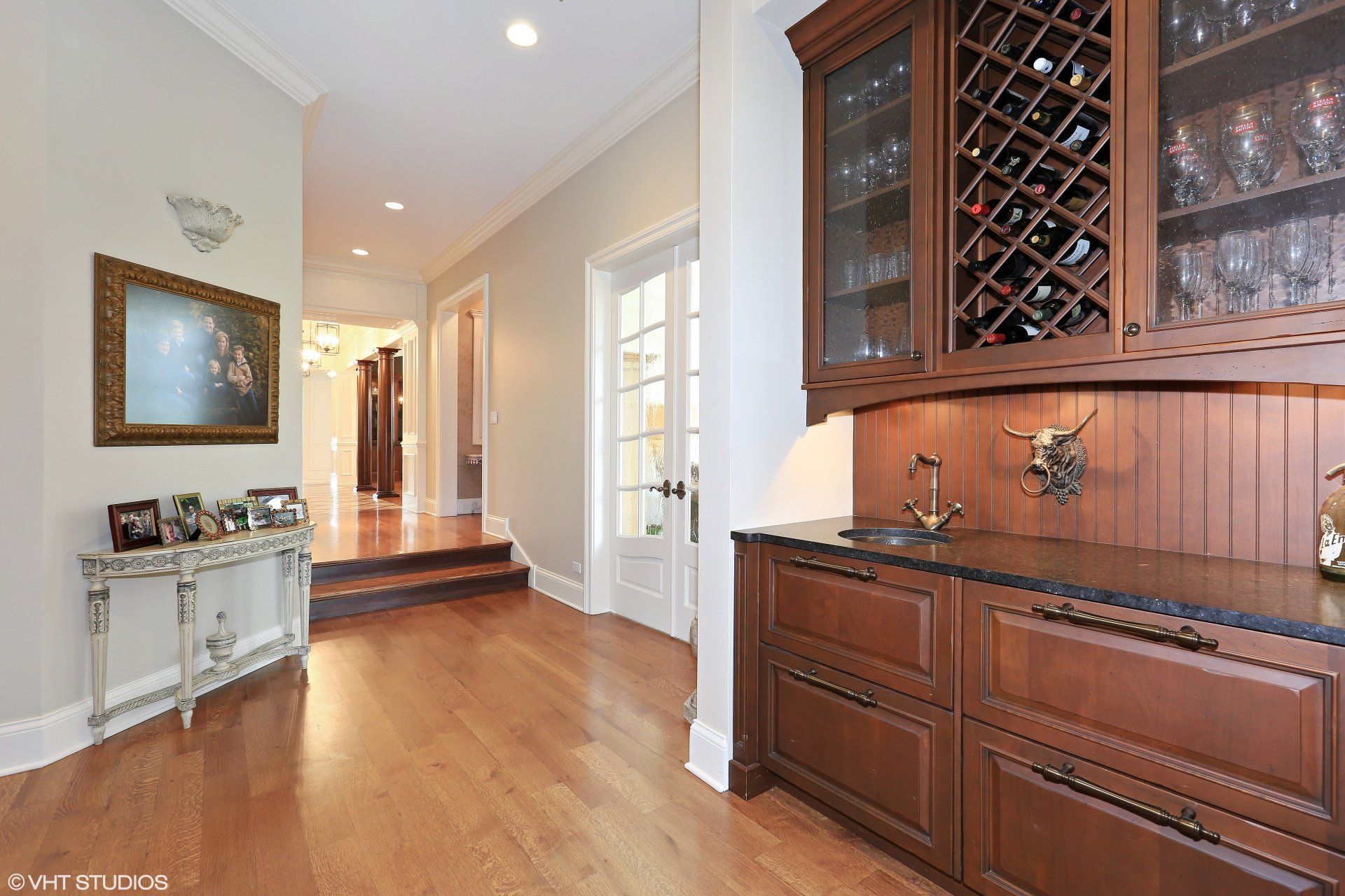 A kitchen with wooden cabinets and a wine rack.