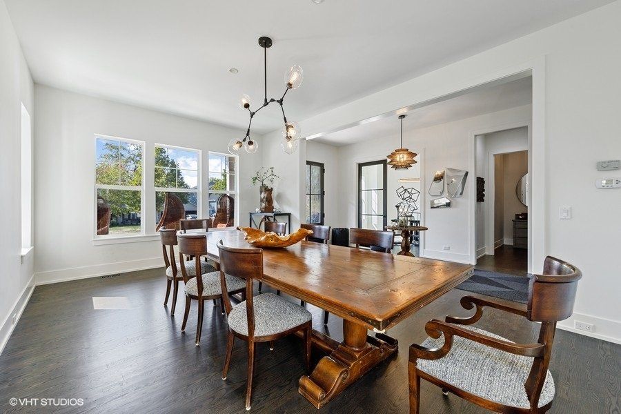 A dining room with a wooden table and chairs