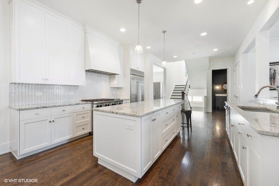 There is a large island in the middle of the kitchen.