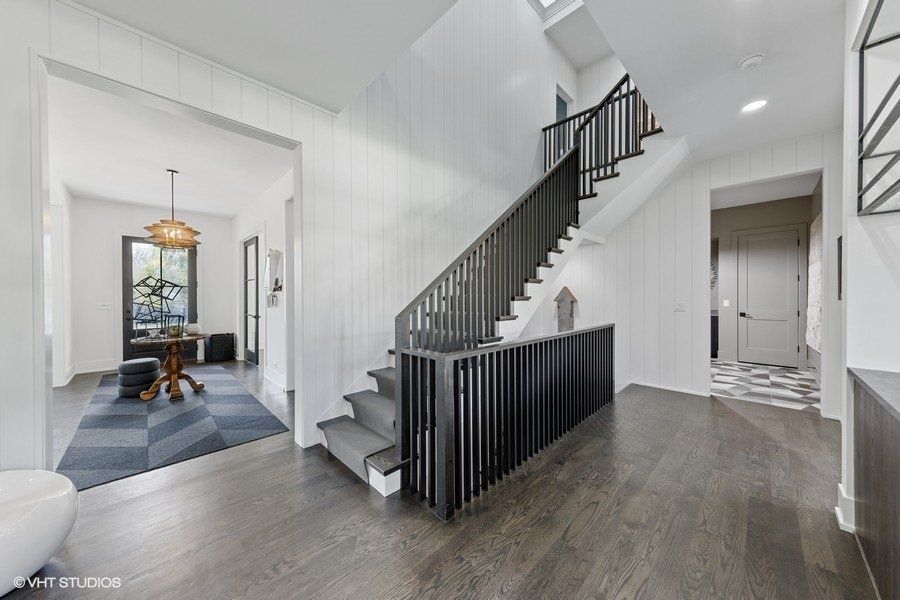A black and white photo of a staircase in a house.