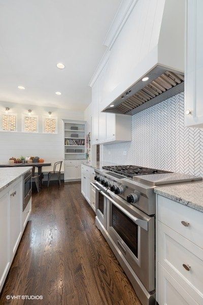 A kitchen with stainless steel appliances and white cabinets