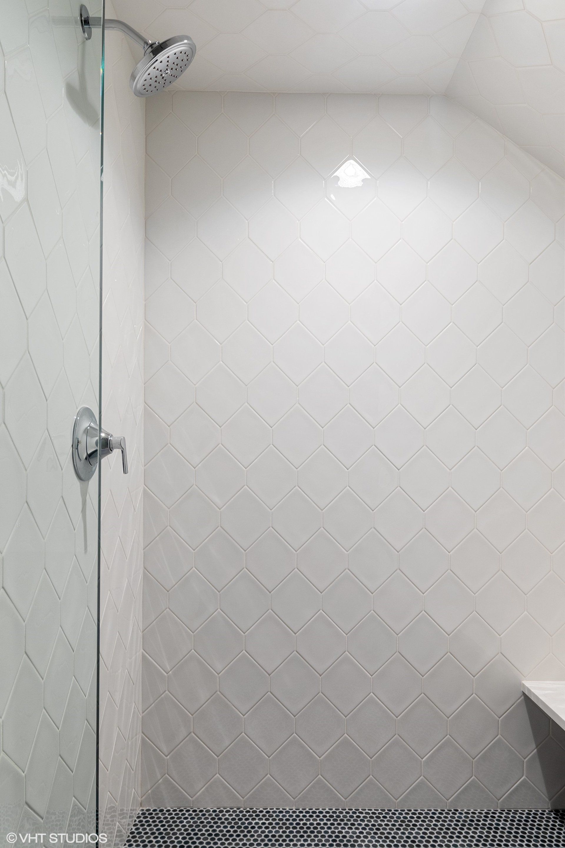 There is a shower with a glass door and a shower head.