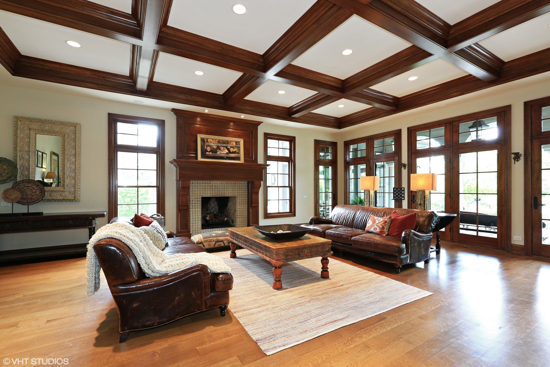 A living room with a couch , chair , coffee table and fireplace.