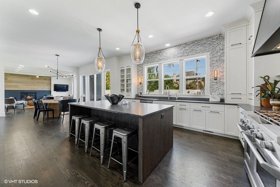 A large kitchen with a large island and stools