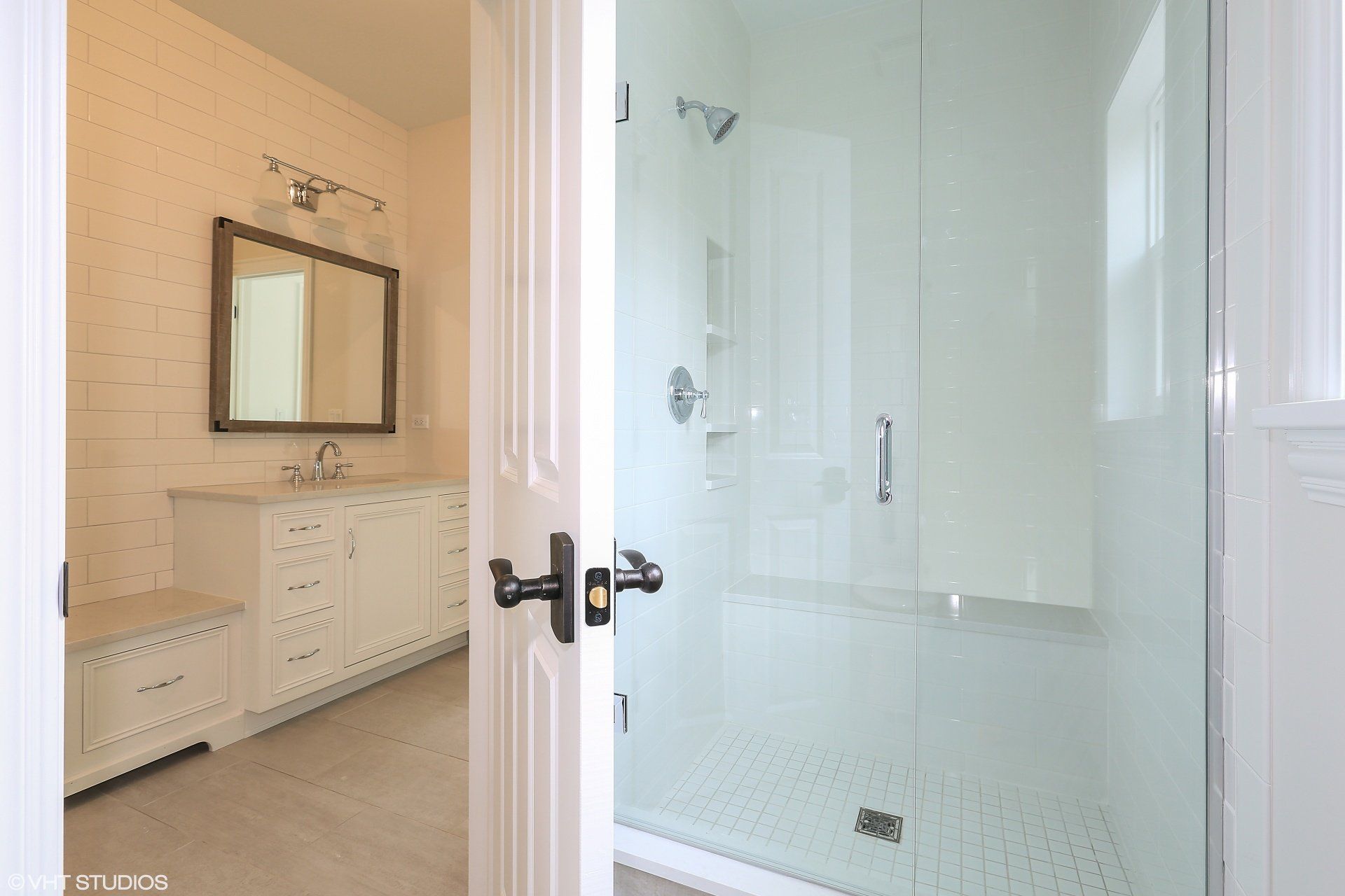 A bathroom with a walk in shower and a sink.