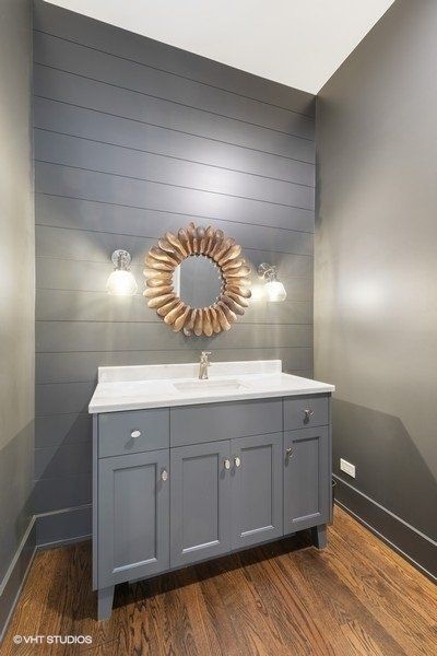 A bathroom with a sink and a mirror on the wall