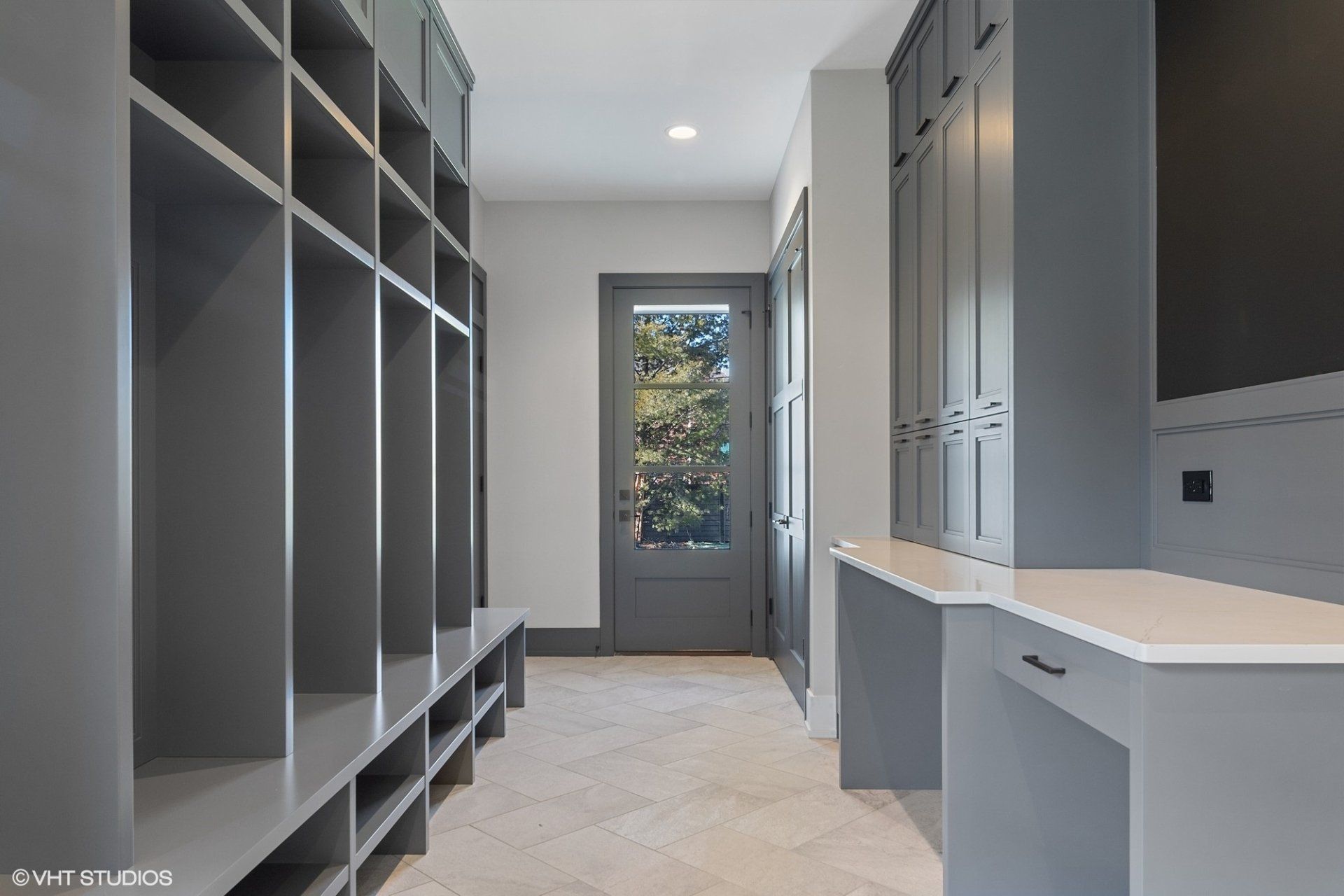 A hallway with a lot of shelves and a door.