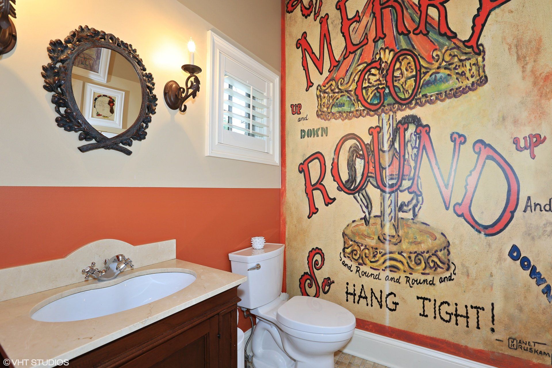 A bathroom with a mural on the wall that says round and hang tight