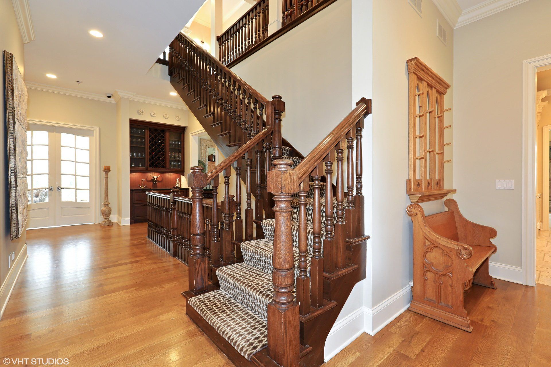 A wooden staircase leading up to the second floor of a house