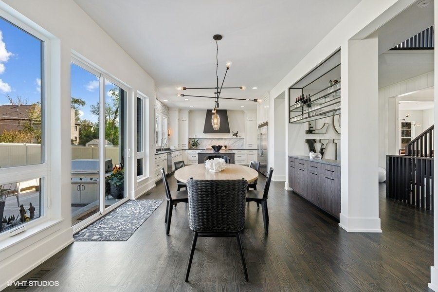 A large dining room with a round table and chairs