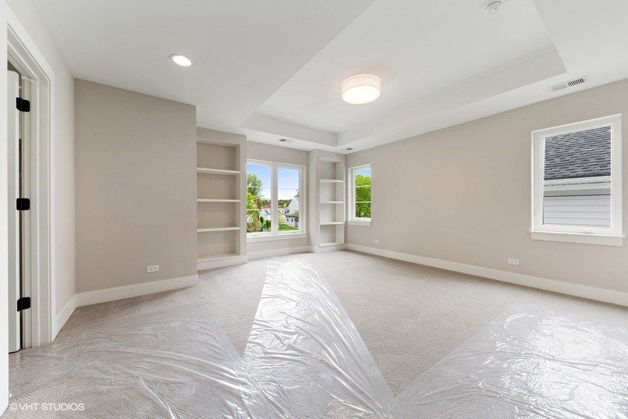 An empty room with a plastic sheet on the floor.