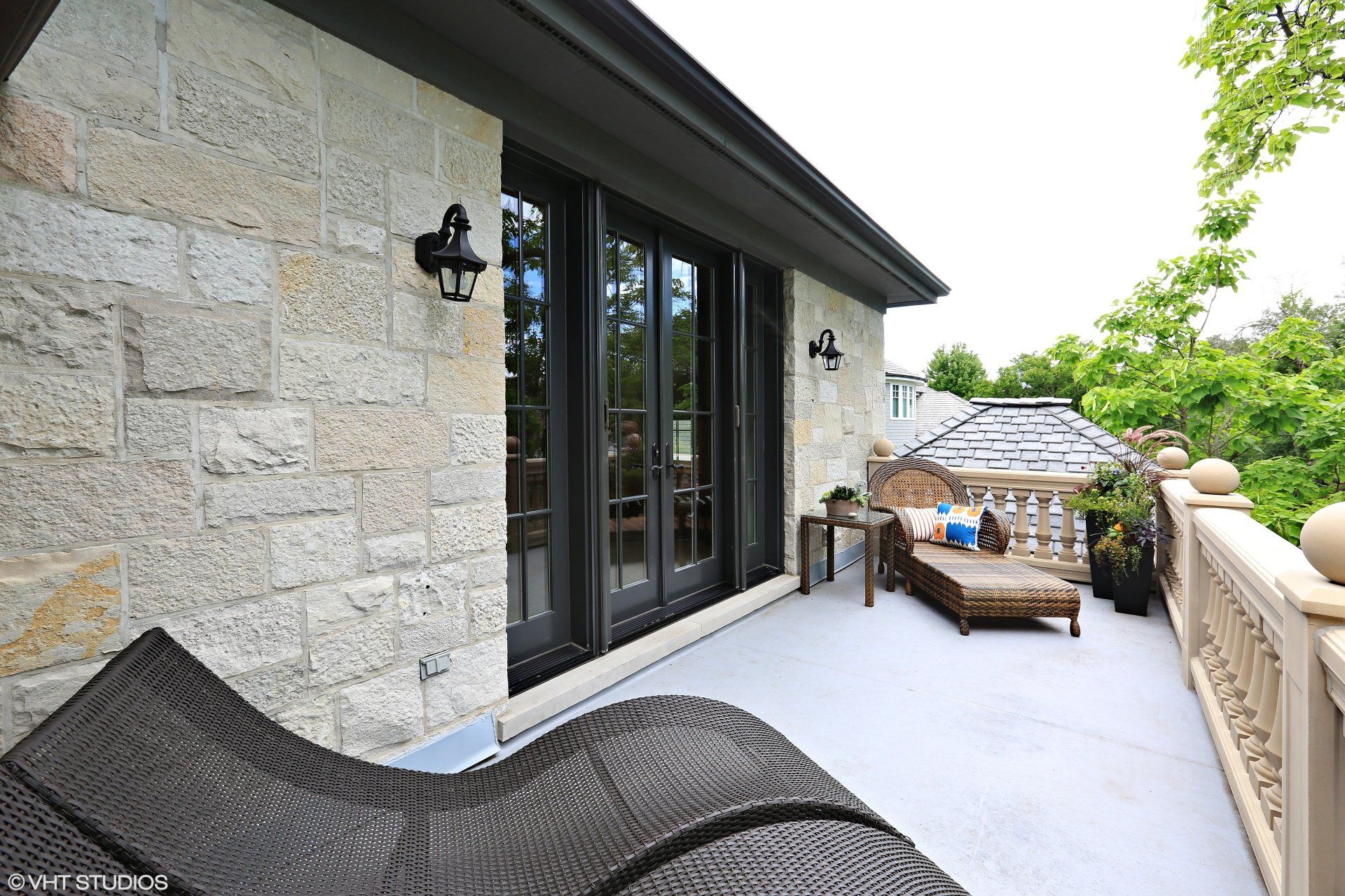 A balcony with a chair and a couch on it