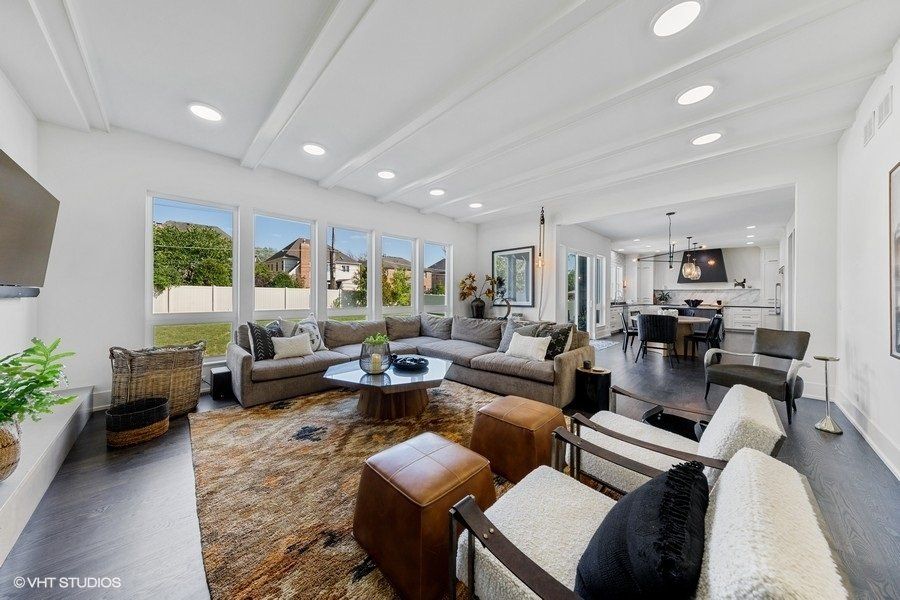 A living room with a lot of furniture and a fireplace.