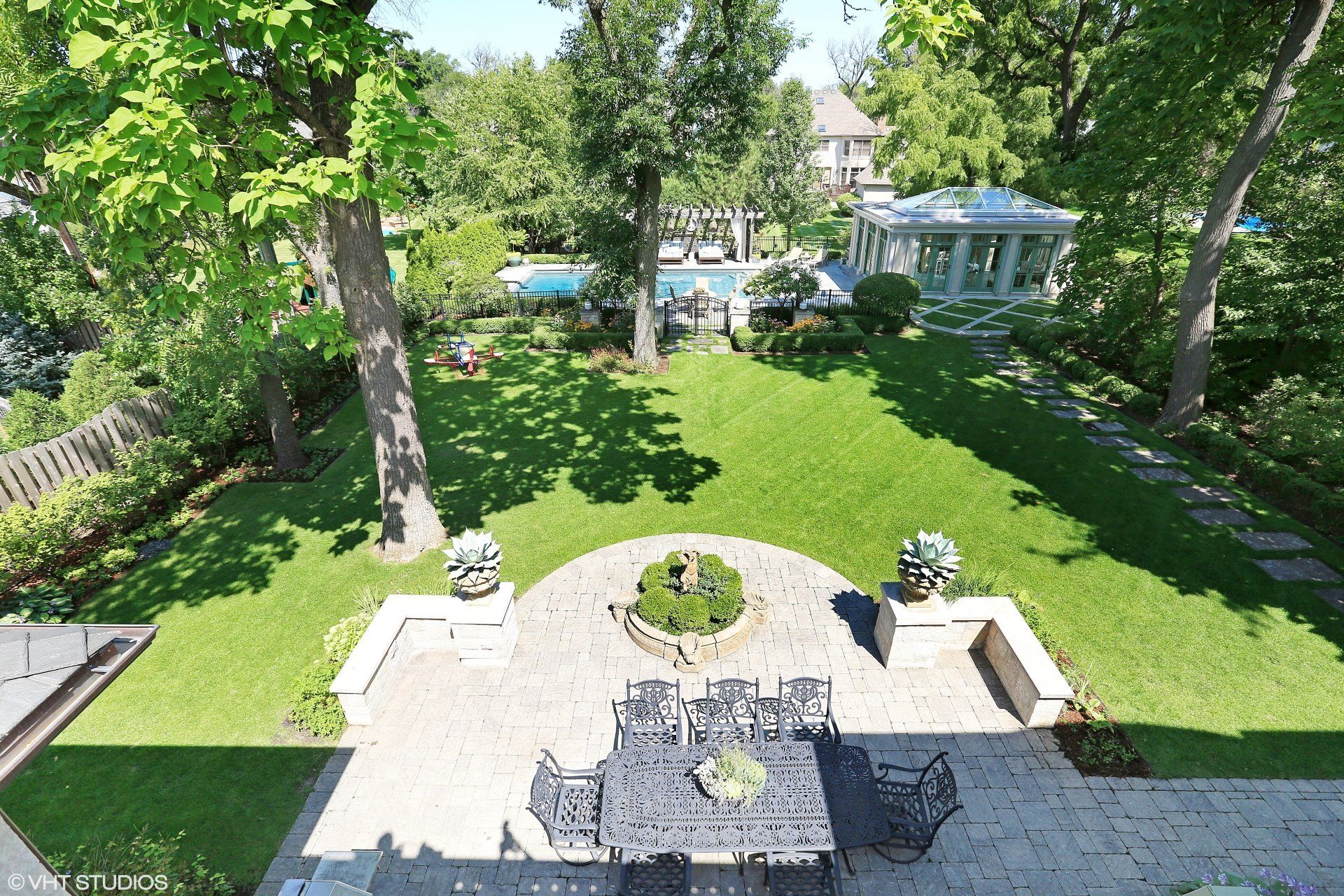 An aerial view of a backyard with a table and chairs